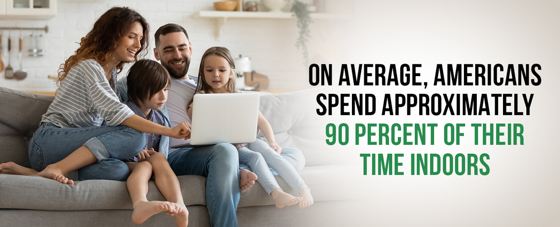 Mother, Father, Daughter and Son on a Couch Watching Something Fun on a Computer