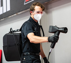 A Technician Spraying the Shield Application Which Protects Surfaces from Mold, Mildew, and Odor-Causing Bacteria