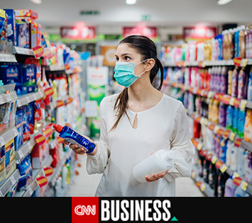 Image of a woman at the supermarket choosing cleaning products